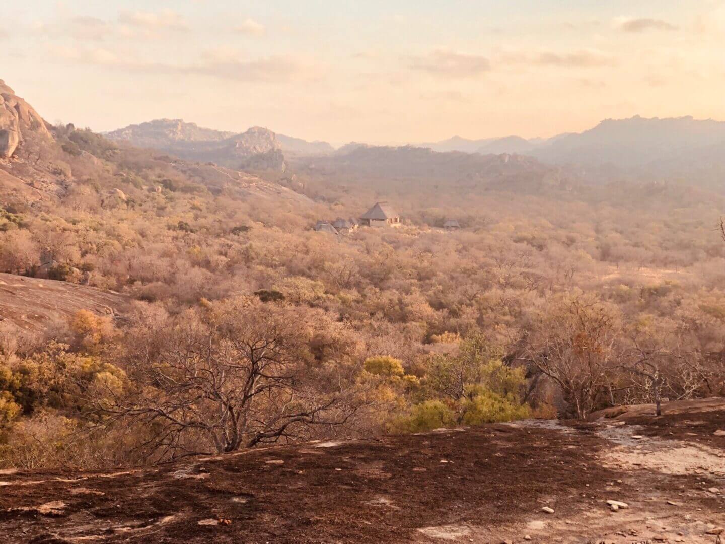 Scenic view of a dry, mountainous landscape at sunset.